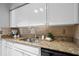Well-lit kitchen with granite counters, updated cabinets, and stainless steel sink at 1150 Collier Nw Rd # E3, Atlanta, GA 30318