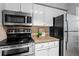 Efficient kitchen layout with stainless steel appliances, ample counter space, and neutral backsplash at 1150 Collier Nw Rd # E3, Atlanta, GA 30318