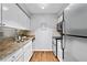 Functional kitchen features white cabinetry, stainless steel appliances, and granite countertops at 1150 Collier Nw Rd # E3, Atlanta, GA 30318