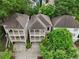An aerial view showcases the home's architecture, complimented by lush green trees and neighboring homes at 737 St Charles Ne Ave, Atlanta, GA 30306