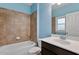Updated bathroom features a shower-tub combo with tiled walls, a sink with vanity, and modern fixtures at 737 St Charles Ne Ave, Atlanta, GA 30306