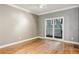 Bedroom with hardwood flooring, neutral walls, and large windows, perfect for relaxation and comfort at 737 St Charles Ne Ave, Atlanta, GA 30306
