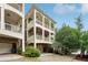 Charming home features multi-level covered balconies, a brick foundation, and a two-car garage at 737 St Charles Ne Ave, Atlanta, GA 30306