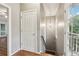 Hallway with staircase, stylish lighting, and access to outdoor porch area through glass paneled door at 737 St Charles Ne Ave, Atlanta, GA 30306