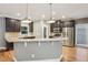 Stylish kitchen featuring stainless steel appliances, granite countertops, and a breakfast bar at 737 St Charles Ne Ave, Atlanta, GA 30306