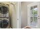 Convenient laundry area with stacked washer and dryer and access to the deck area at 737 St Charles Ne Ave, Atlanta, GA 30306