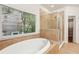 A spacious main bathroom features a shower, tile floors and a large window at 737 St Charles Ne Ave, Atlanta, GA 30306