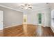 A spacious main bedroom features hardwood floors, white paint and a door to the outside at 737 St Charles Ne Ave, Atlanta, GA 30306