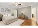 A spacious main bedroom features a ceiling fan, beautiful art and wood floors at 737 St Charles Ne Ave, Atlanta, GA 30306