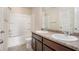 Bathroom featuring double sink vanity, shower and tub combo and tile flooring at 115 Oakwood Dr, Covington, GA 30016
