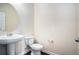 Neutral bathroom featuring a pedestal sink, toilet, large mirror, and tile floors at 115 Oakwood Dr, Covington, GA 30016