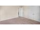 Neutral bedroom with carpet, baseboard trim, and double door closet at 115 Oakwood Dr, Covington, GA 30016