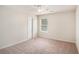 Bedroom featuring neutral walls and carpet, window, and door at 115 Oakwood Dr, Covington, GA 30016