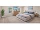 Bright primary bedroom featuring neutral walls, carpet, and several windows allowing for ample natural light at 115 Oakwood Dr, Covington, GA 30016