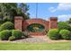 Elegant brick entrance sign for Oakwood Manor, surrounded by lush greenery at 115 Oakwood Dr, Covington, GA 30016