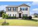 Charming two-story home with a manicured lawn and black shutters on the windows at 115 Oakwood Dr, Covington, GA 30016