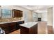 Bright kitchen featuring an island, stainless steel appliances, granite countertops, and seamless access to the living area at 115 Oakwood Dr, Covington, GA 30016
