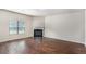 Open living room with hardwood floors, fireplace, and natural light at 115 Oakwood Dr, Covington, GA 30016