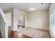 Open living room with hardwood floors and lots of natural light streaming through a large window at 115 Oakwood Dr, Covington, GA 30016