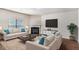 Comfortable living room with a fireplace, plush seating, and bright, natural light at 115 Oakwood Dr, Covington, GA 30016
