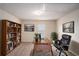 Well-lit office with a built-in bookshelf, plush chair, and modern decor at 115 Oakwood Dr, Covington, GA 30016
