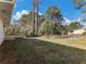 Large grassy backyard featuring a wooden deck and a variety of mature trees at 1783 Big Valley Ln, Stone Mountain, GA 30083