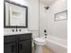 Modern bathroom with dark vanity and shower with white marble tile at 1783 Big Valley Ln, Stone Mountain, GA 30083