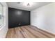 Modern bedroom featuring light colored floors and a dark accent wall at 1783 Big Valley Ln, Stone Mountain, GA 30083