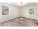 Bright bedroom with two windows and light wood flooring throughout at 1783 Big Valley Ln, Stone Mountain, GA 30083