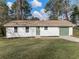Charming single-story home with a well-manicured lawn, green door, and matching garage door at 1783 Big Valley Ln, Stone Mountain, GA 30083