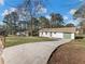Home featuring a long concrete driveway leading to the front of the property at 1783 Big Valley Ln, Stone Mountain, GA 30083
