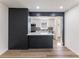 Open-concept kitchen with dark accent wall and modern finishes at 1783 Big Valley Ln, Stone Mountain, GA 30083