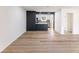 Spacious living room area with modern flooring and a kitchen view at 1783 Big Valley Ln, Stone Mountain, GA 30083