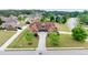 An aerial view of a brick house with a long driveway and symmetrical landscaping at 401 Sara Ct, Loganville, GA 30052