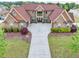A stunning aerial view shows the home's brick facade, manicured lawn and long driveway at 401 Sara Ct, Loganville, GA 30052