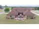 Aerial view of backyard, patio, landscaping, and brown brick home at 401 Sara Ct, Loganville, GA 30052