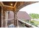 Charming stone balcony with wrought iron furniture and roof views at 401 Sara Ct, Loganville, GA 30052