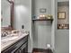 Stylish half bath with granite countertop, modern fixtures, and decorative accents at 401 Sara Ct, Loganville, GA 30052