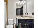 Bathroom featuring modern vanity with granite countertops and updated fixtures at 401 Sara Ct, Loganville, GA 30052