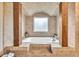 Soaking tub in elegant bathroom with brick design and wood columns at 401 Sara Ct, Loganville, GA 30052