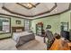 Bright bedroom with a tray ceiling, large windows, and carpet flooring with space for a desk at 401 Sara Ct, Loganville, GA 30052