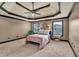 Spacious bedroom showcasing a decorative tray ceiling, plush carpeting, and natural light at 401 Sara Ct, Loganville, GA 30052