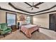 Spacious bedroom showcasing a decorative tray ceiling, plush carpeting, and natural light at 401 Sara Ct, Loganville, GA 30052