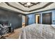 Bedroom with a chalkboard wall, tray ceiling and dark trim, with an attached bathroom at 401 Sara Ct, Loganville, GA 30052