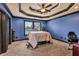 Stylish bedroom boasting a unique tray ceiling, plush carpeting, and plenty of natural light at 401 Sara Ct, Loganville, GA 30052