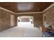 Open carport features brick walls, wood ceilings, and provides seamless transition at 401 Sara Ct, Loganville, GA 30052
