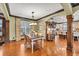 Elegant dining area features hardwood floors, a chandelier, arched doorways, and an open view of the kitchen at 401 Sara Ct, Loganville, GA 30052