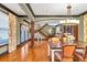 Open-concept dining room features hardwood floors, a modern chandelier, and natural light at 401 Sara Ct, Loganville, GA 30052