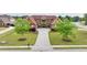 Brick home with a manicured lawn, symmetrical landscaping, and a long driveway at 401 Sara Ct, Loganville, GA 30052