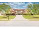 Brick home with a manicured lawn, symmetrical landscaping, and a long driveway at 401 Sara Ct, Loganville, GA 30052